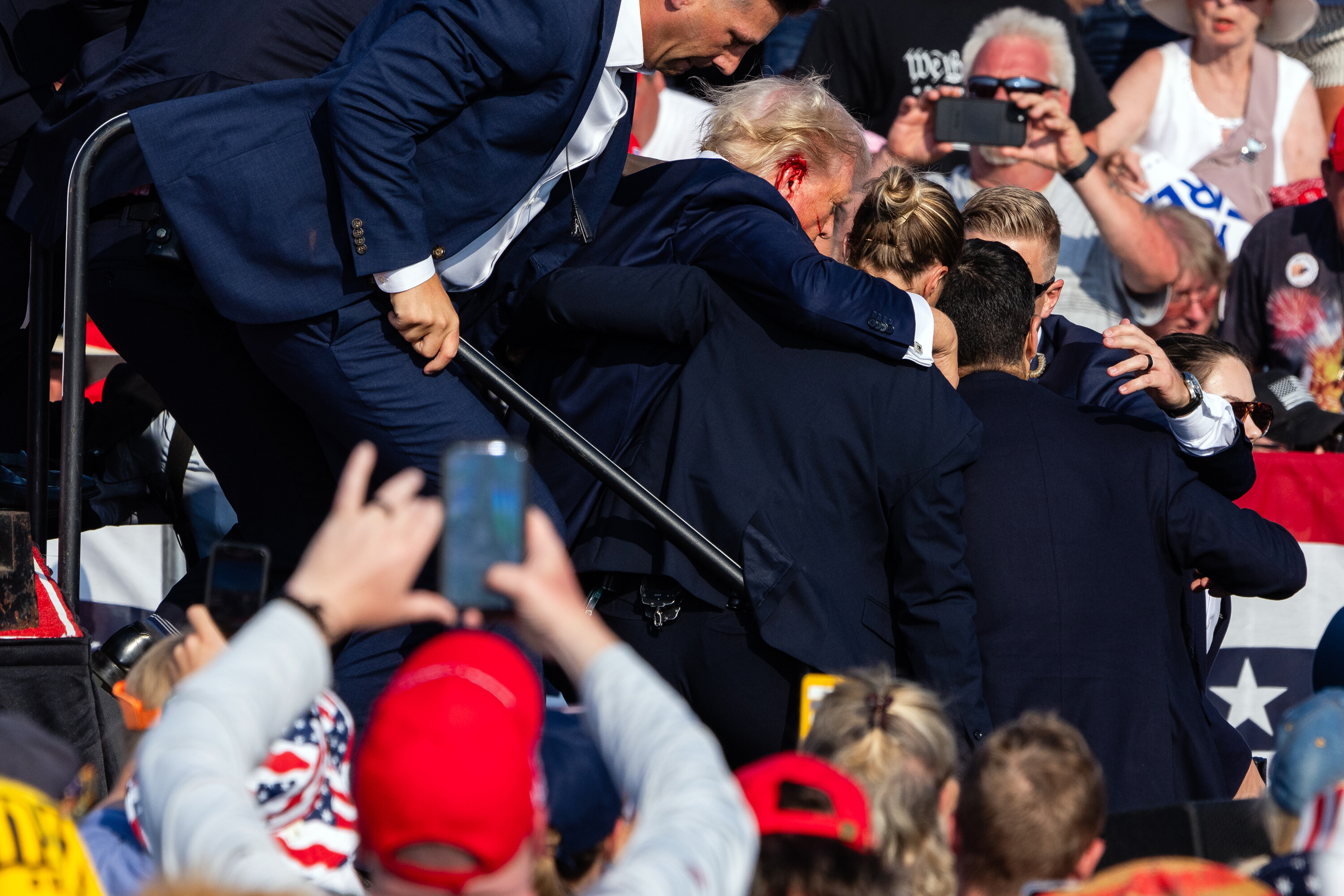 GW alumnus Eric Lee, while working for the New York Times, took this photo of former President Donald Trump leaving the stage after being shot at a rally on July 13 in Butler, Pa. (Eric Lee/The New York Times/Redux)