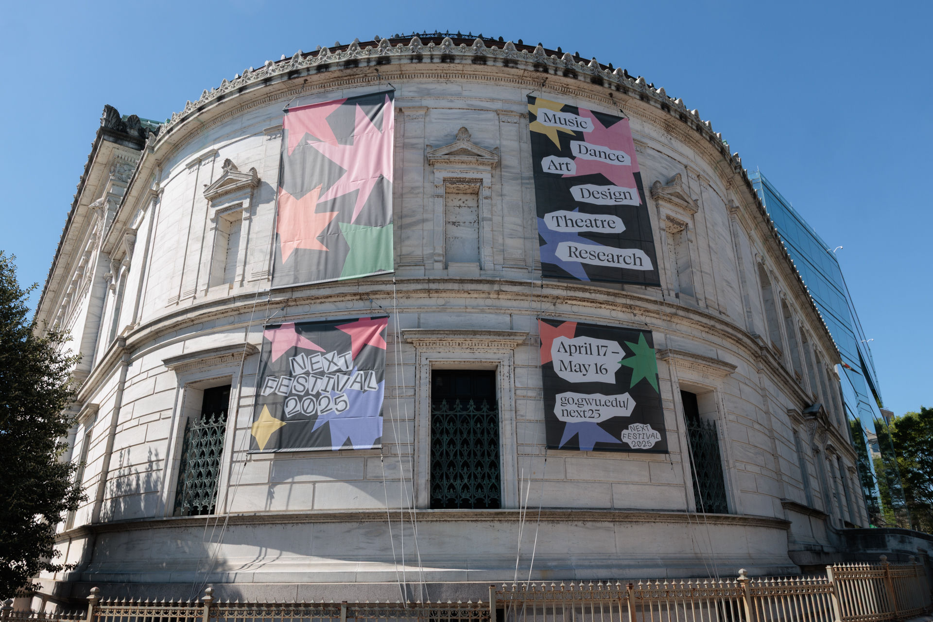 Promotional materials for this year's NEXT Festival, including the banners adorning the Flagg Building, were designed by students. (William Atkins/GW Today)