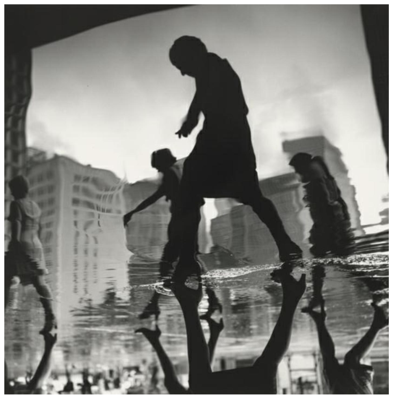 In this photograph, Tress captured women—office workers, per title— in heels, returning home. Perhaps because of the rain or the flood from somewhere, the ground is filled with the  water and the reflection in the water almost looks like the child walking. In the late 1950s and early 1960s, Tress began to search for ways to exceed the everyday look of life, to go beyond  experience. Tress tried to exert his feeling for the world with a sense of the extraordinary. 