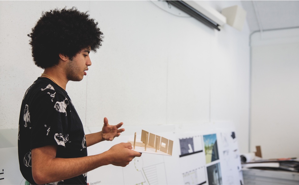 Student presenting in front of white board