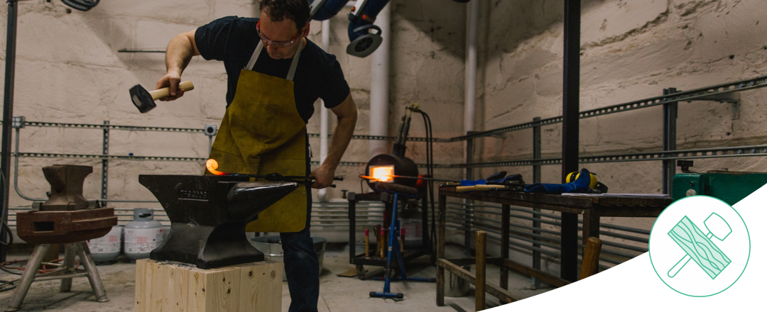 Student using hammer in metal shop
