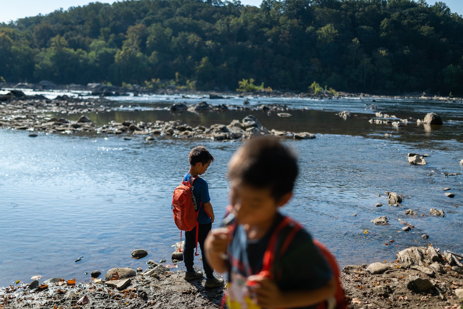 Children by a river bank