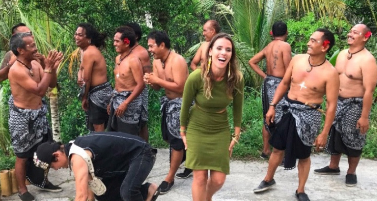 Woman laughing in the jungle with native peoples