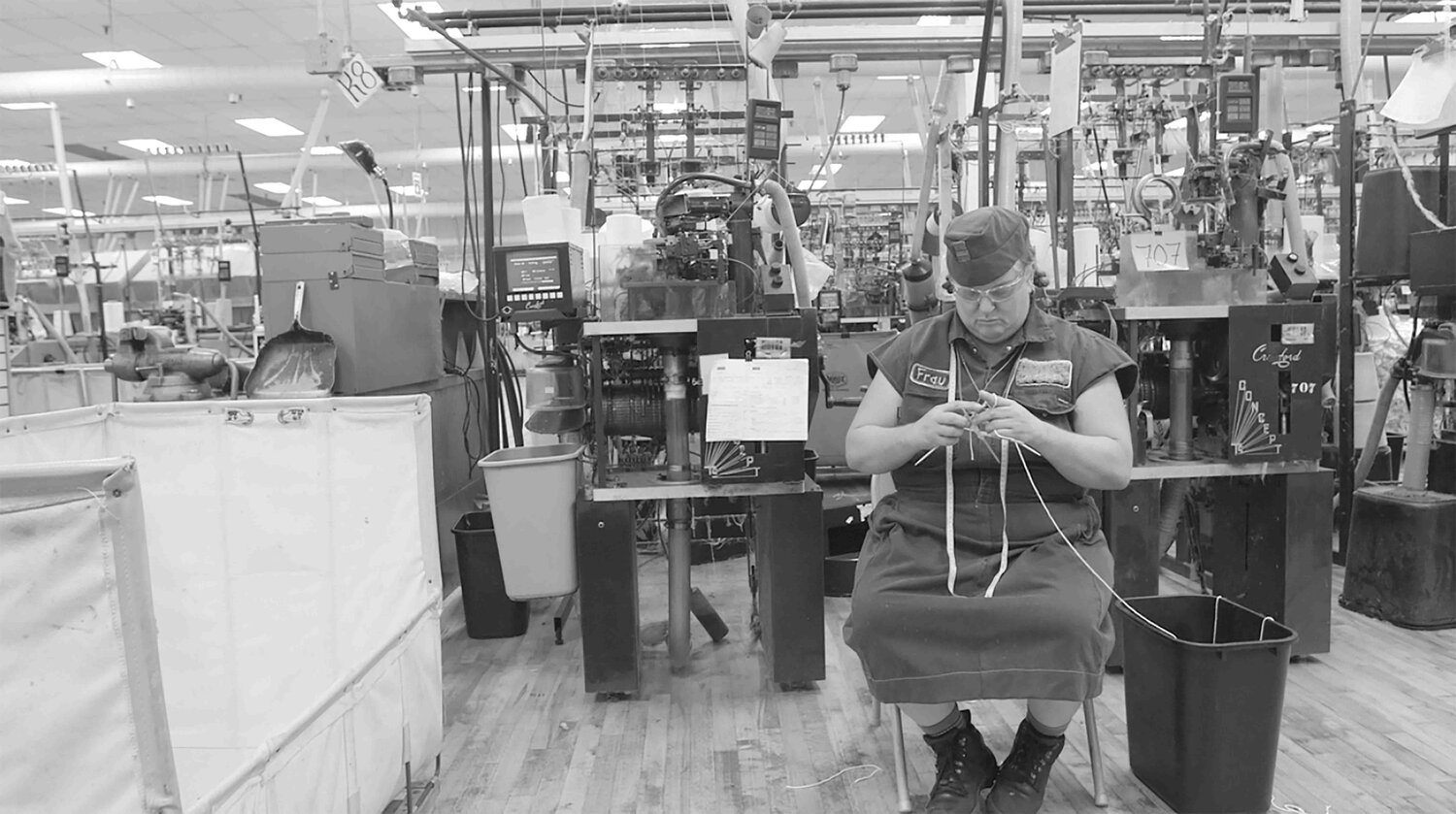 A woman knitting in a factory
