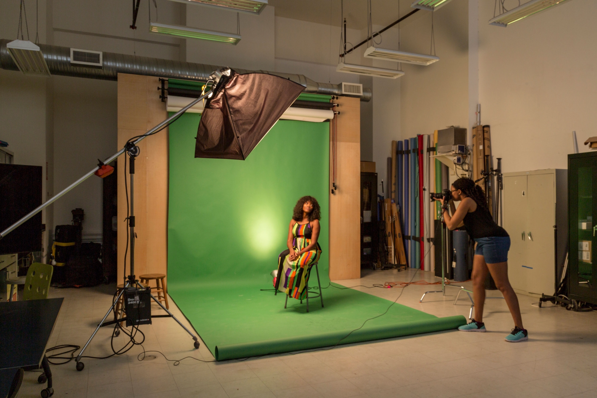 Students taking a photo in the lighting studio