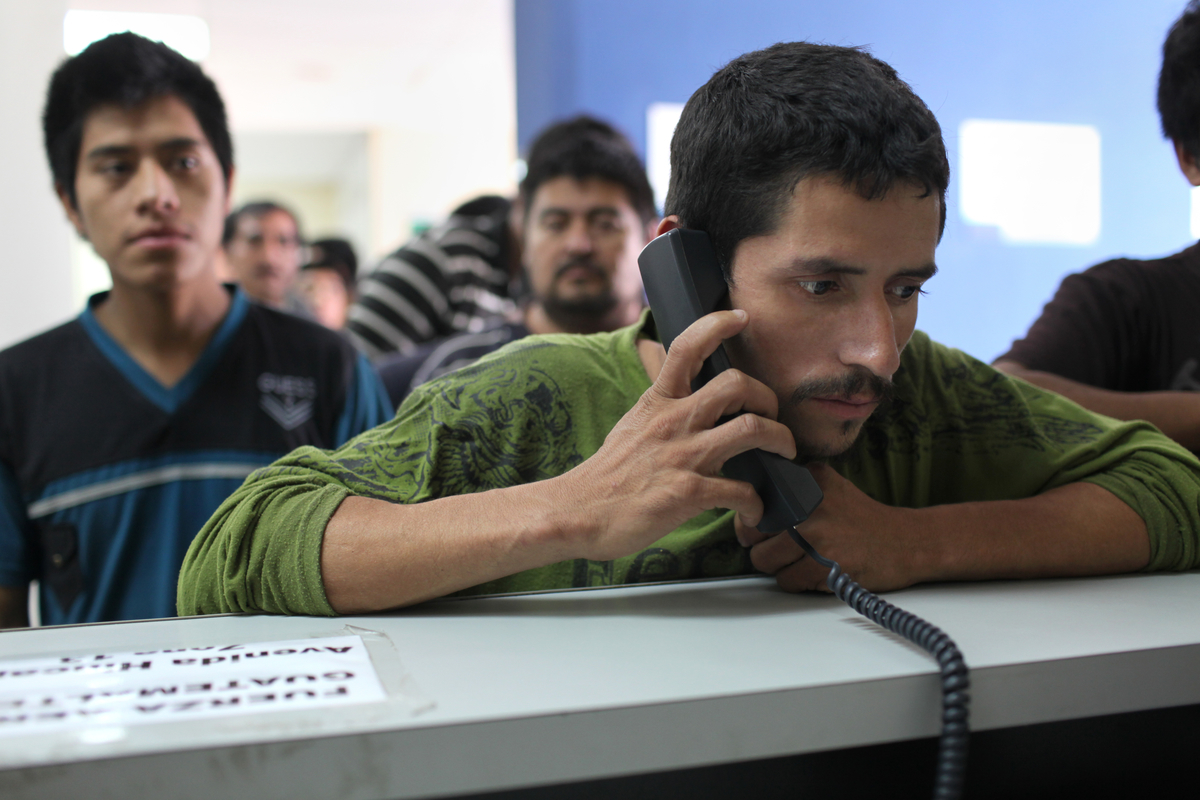 A man makes a phone call after being deported