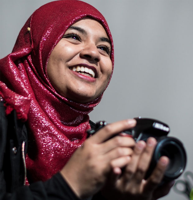 smiling student with camera