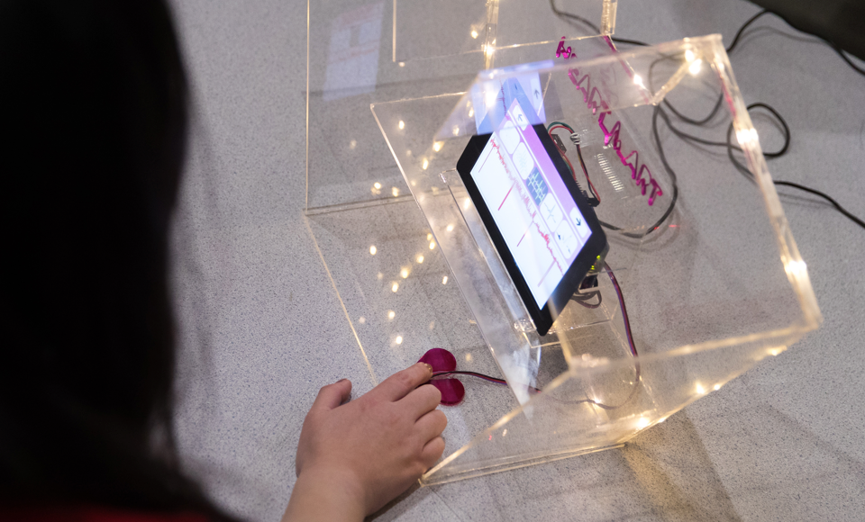 A woman manipulates a digital map via toggle switches
