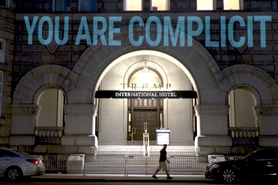 A projection from Robin Bell's "Emoluments Welcome." (bellvisuals.com)