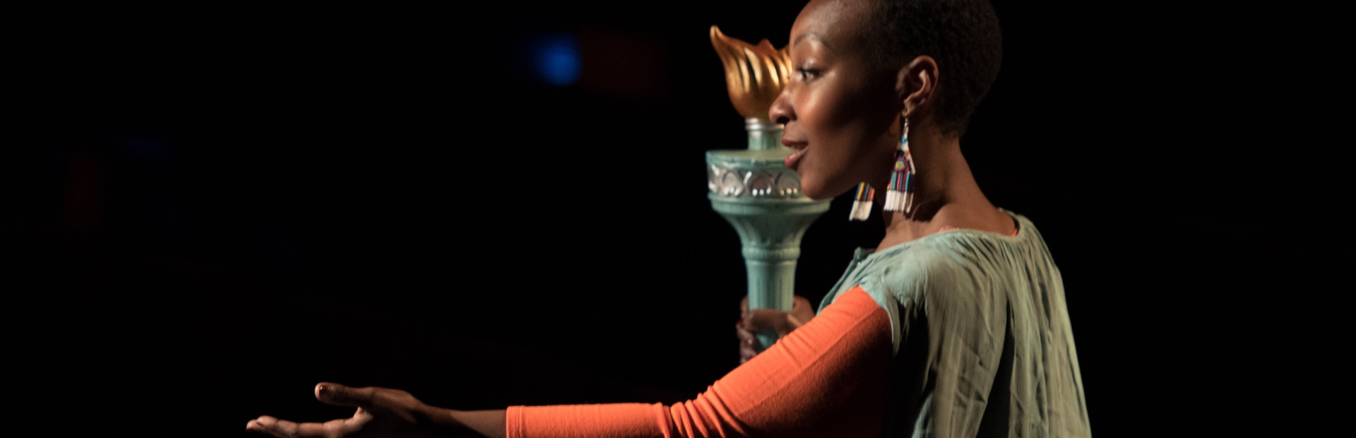 Female student on stage with flame