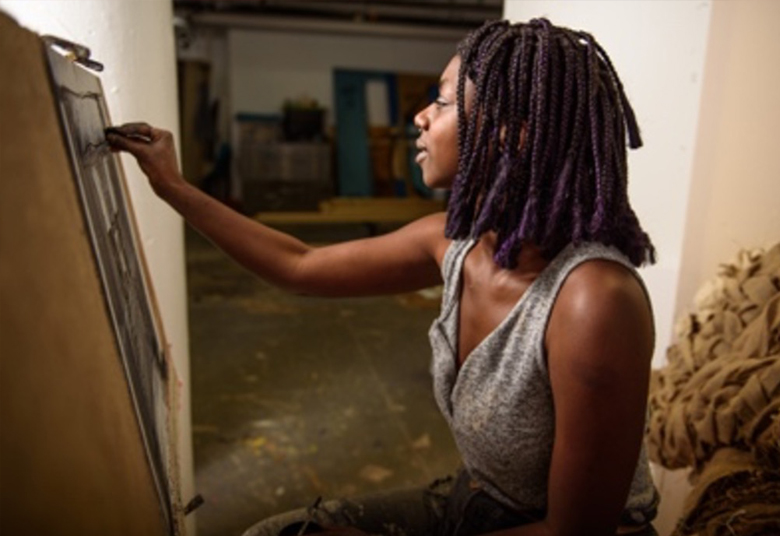 Student working at easel