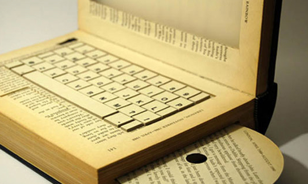 A laptop computer made of old printed materials and books