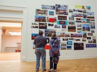 Visitors look at the Billboards exhibit installed in the Corcoran Gallery of Art as part of the For Freedoms residency.