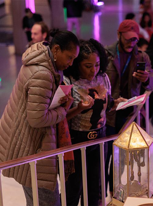 Two women observe a work of art