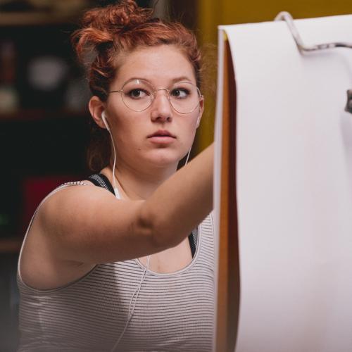 student drawing at an easel