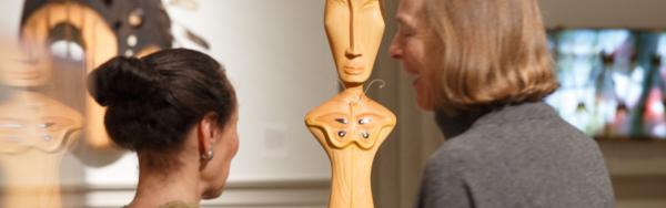 student and professor looking at artwork