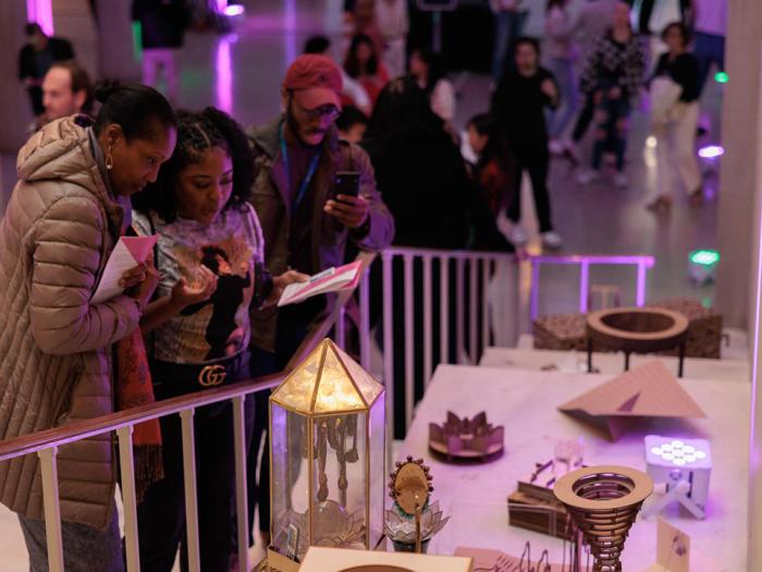 Viewers admire final projects by Corcoran interior architecture students at the NEXT Festival in spring 2023. (William Atkins/GW Today)