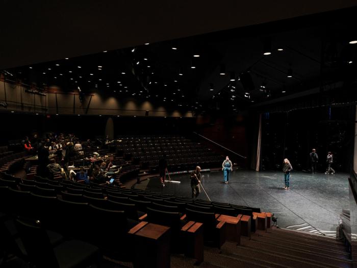 The tech crew cleans and prepares the stage prior to dance rehearsal in the Dorothy Betts Marvin Theatre