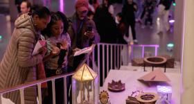 Viewers admire final projects by Corcoran interior architecture students at the NEXT Festival in spring 2023. (William Atkins/GW Today)