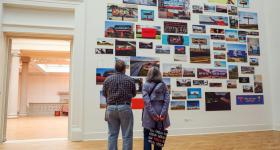 Visitors look at the Billboards exhibit installed in the Corcoran Gallery of Art as part of the For Freedoms residency.